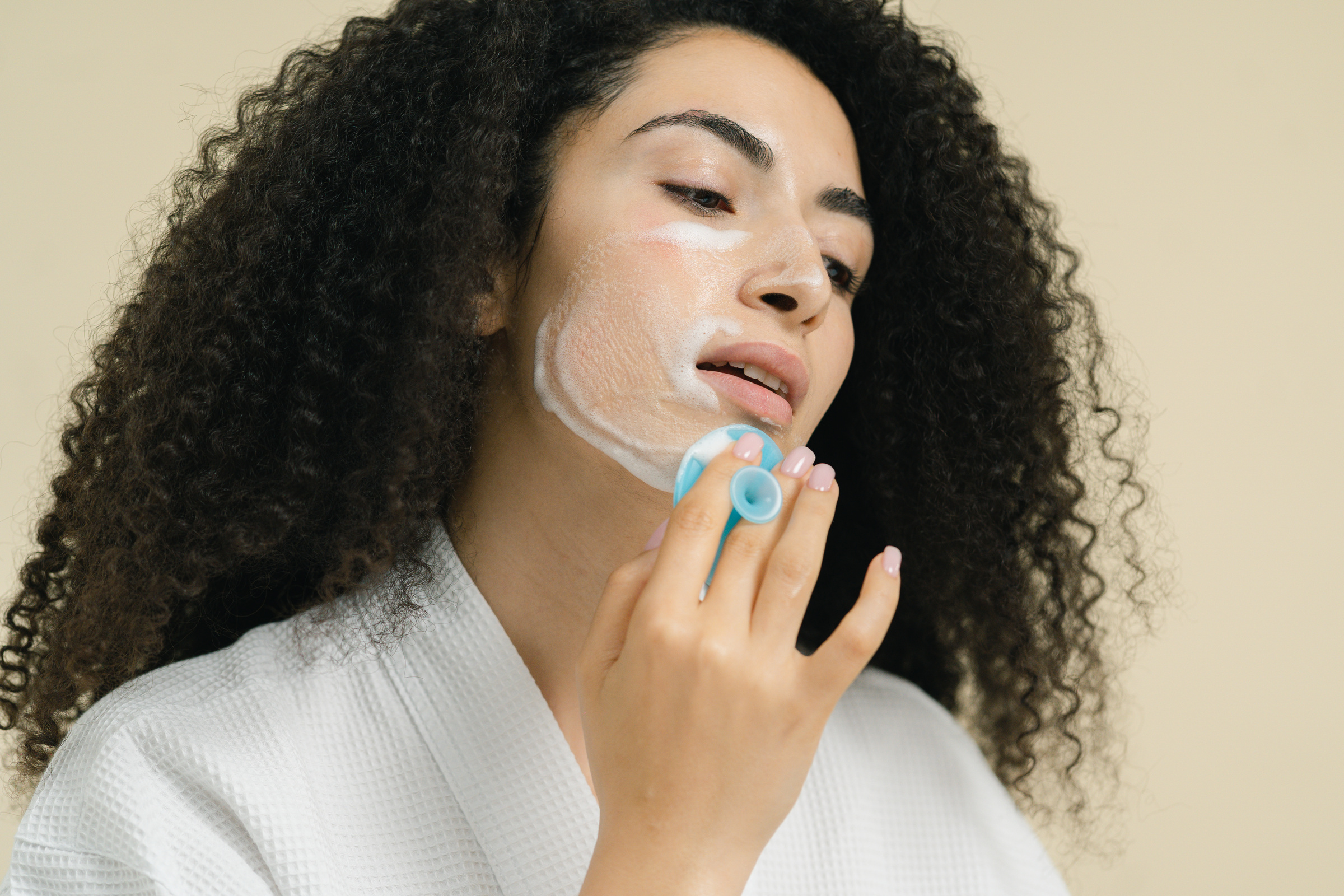 Photo of a Woman Using a Facial Cleanser